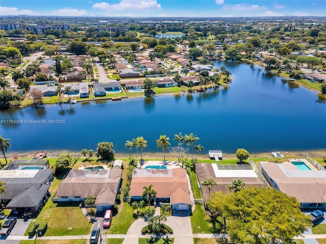 drone / aerial view with a residential view and a water view