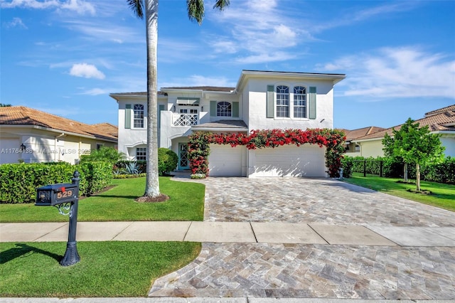 view of front facade featuring a garage, stucco siding, decorative driveway, and a front lawn