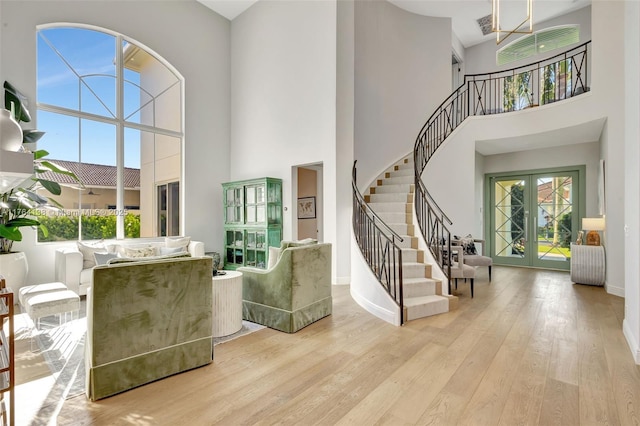 foyer featuring french doors, stairs, and wood finished floors