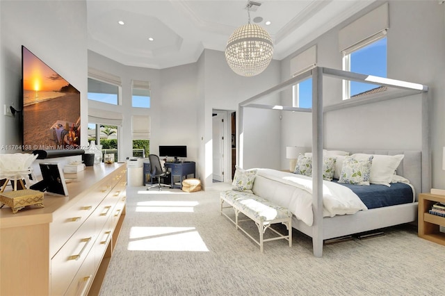 bedroom with visible vents, a high ceiling, carpet flooring, crown molding, and a chandelier