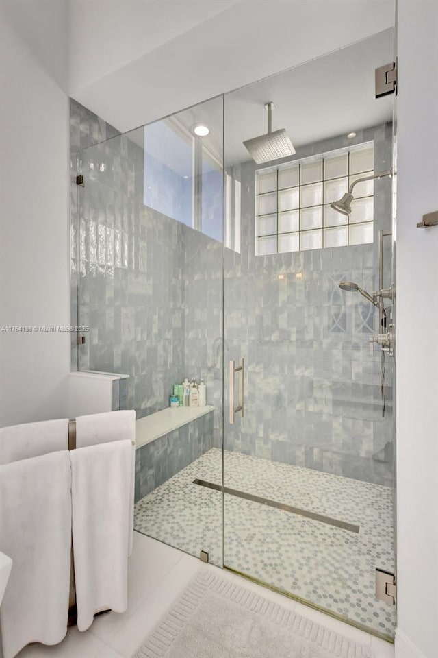 full bath with tile patterned flooring and a shower stall