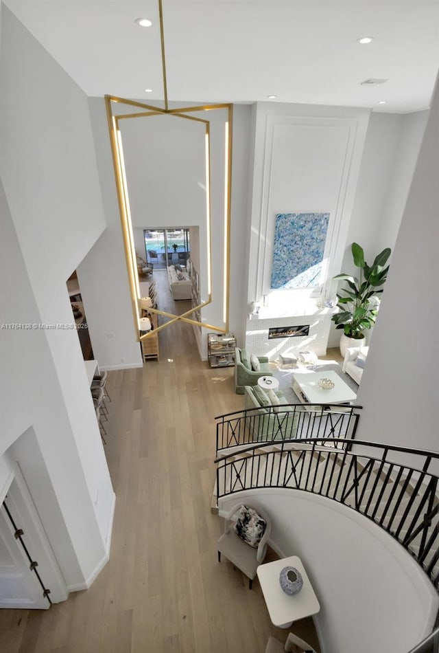 stairway featuring recessed lighting and wood finished floors