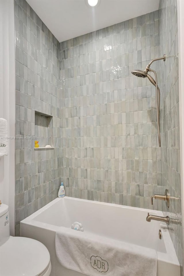 bathroom with shower / bathing tub combination and toilet