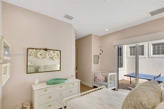 bedroom featuring recessed lighting, visible vents, baseboards, and wood finished floors