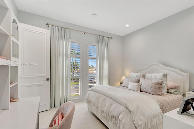 bedroom with access to exterior, recessed lighting, and light carpet