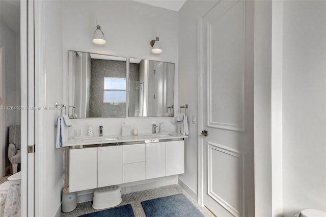 full bath featuring double vanity, walk in shower, and a sink