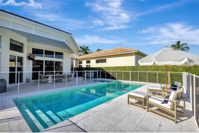 view of pool with a fenced in pool and a patio area