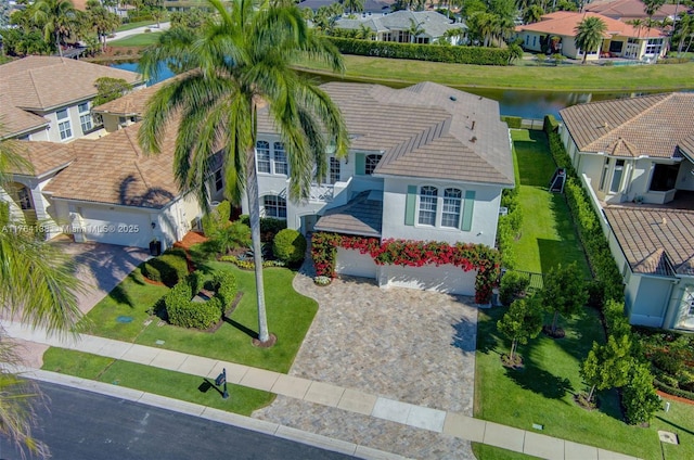 drone / aerial view with a residential view and a water view