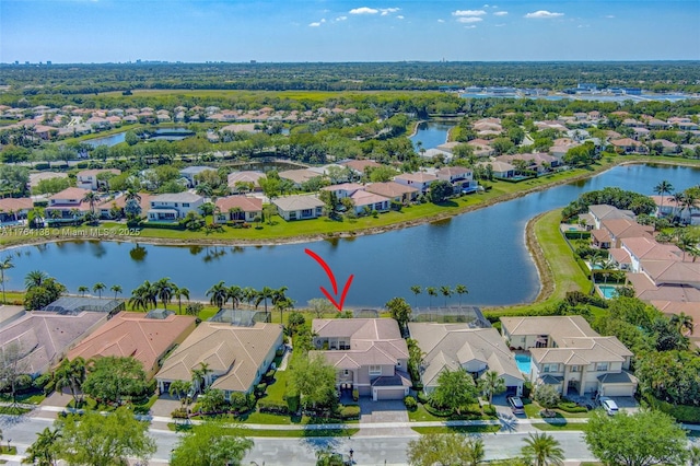 drone / aerial view with a residential view and a water view