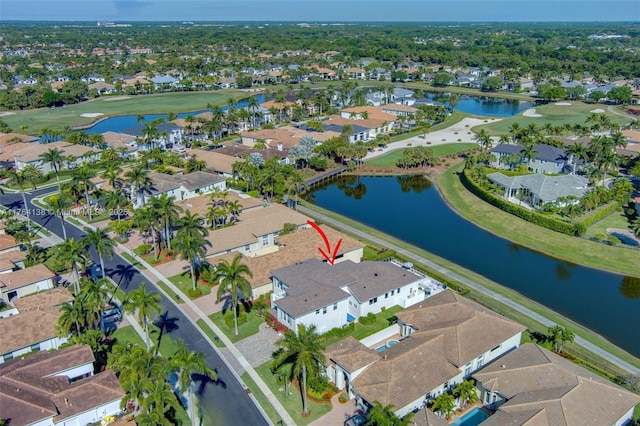 aerial view featuring a residential view, golf course view, and a water view