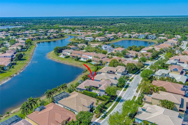 drone / aerial view with a residential view and a water view