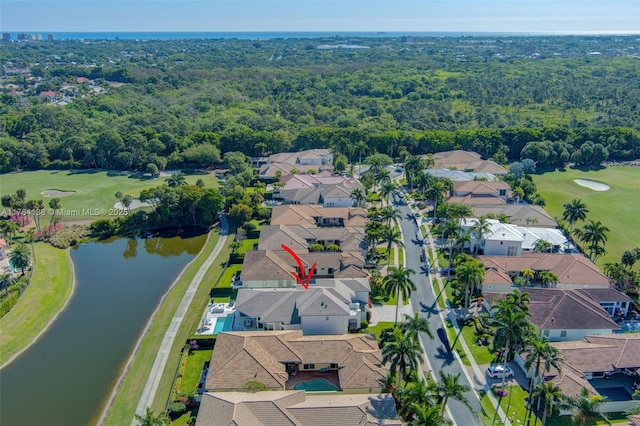 birds eye view of property with a residential view, a view of trees, golf course view, and a water view