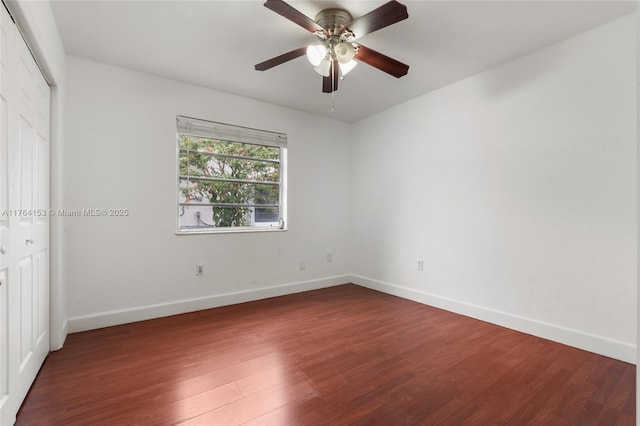 unfurnished bedroom featuring a closet, baseboards, wood finished floors, and a ceiling fan