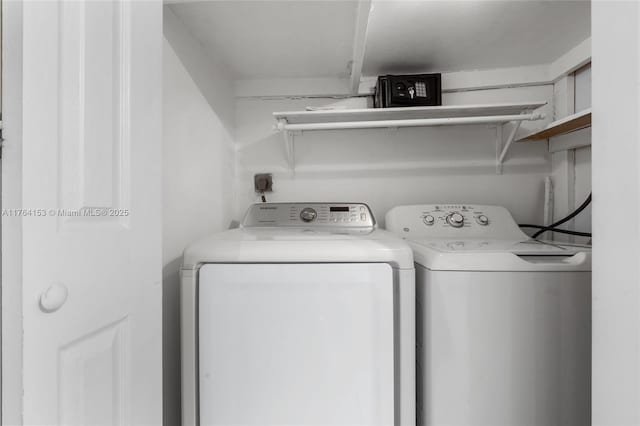 washroom with independent washer and dryer and laundry area