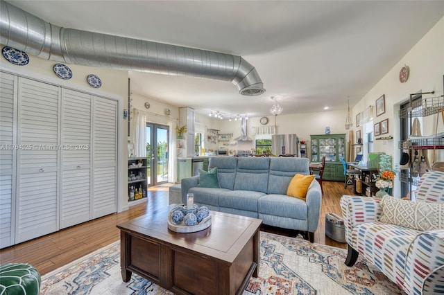 living area with visible vents and wood finished floors