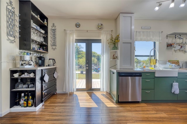 interior space featuring light wood finished floors, green cabinetry, open shelves, and stainless steel dishwasher