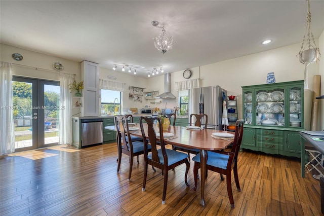 dining area featuring a healthy amount of sunlight, french doors, and dark wood-style flooring