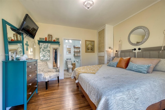 bedroom featuring connected bathroom and wood-type flooring