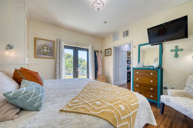 bedroom featuring access to exterior, wood finished floors, visible vents, and french doors