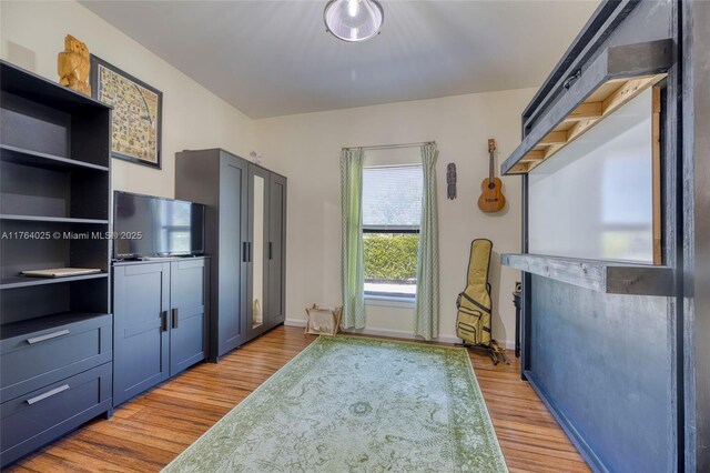 kitchen featuring light countertops, light wood-style floors, and baseboards