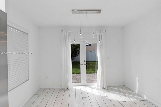 empty room featuring french doors and wood finished floors