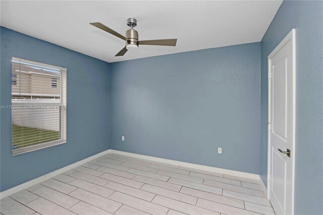 empty room featuring baseboards and ceiling fan