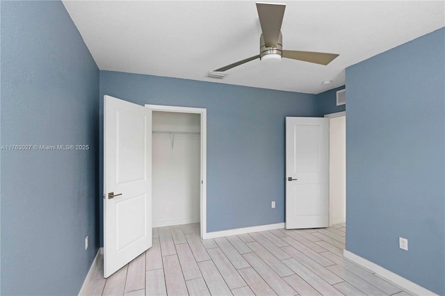 unfurnished bedroom with light wood finished floors, visible vents, baseboards, a closet, and a ceiling fan