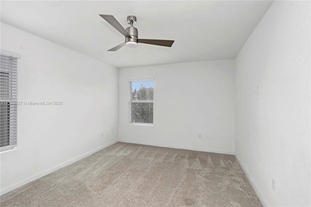 empty room featuring ceiling fan, baseboards, and carpet