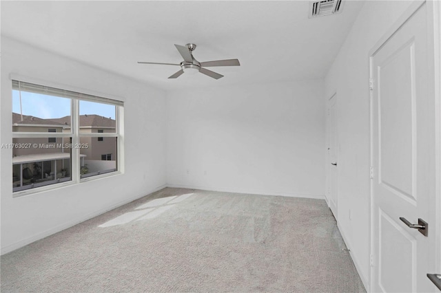 spare room featuring baseboards, carpet, visible vents, and ceiling fan