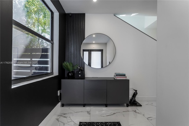 interior space featuring recessed lighting, marble finish floor, vanity, and baseboards