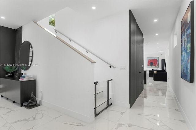 hallway with recessed lighting, marble finish floor, and baseboards