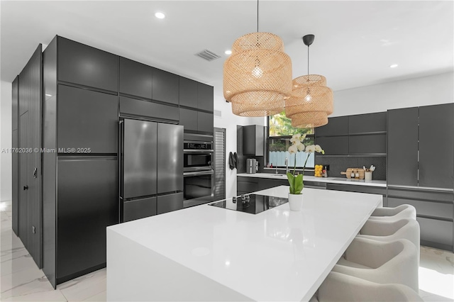 kitchen with appliances with stainless steel finishes, pendant lighting, modern cabinets, marble finish floor, and backsplash