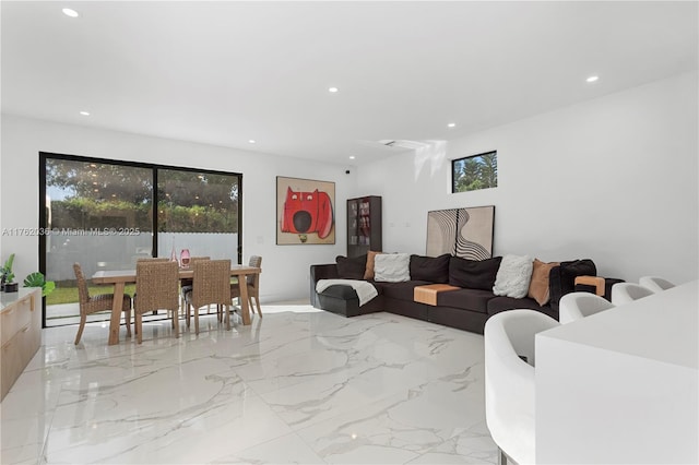 living area featuring recessed lighting and marble finish floor