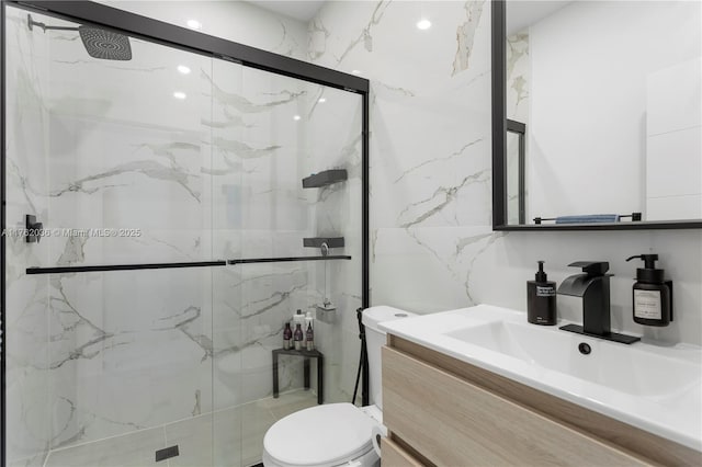 bathroom featuring vanity, tile walls, toilet, and a marble finish shower