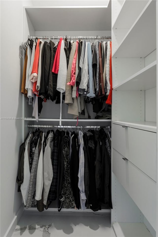 spacious closet with marble finish floor