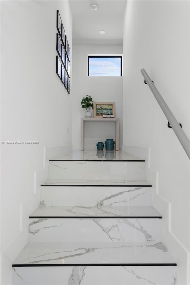 stairs featuring marble finish floor