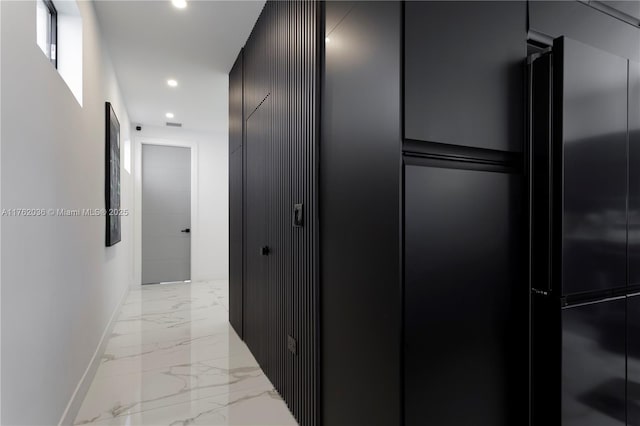 hall featuring recessed lighting, baseboards, and marble finish floor