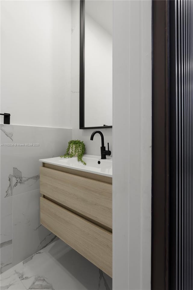 bathroom with marble finish floor and vanity