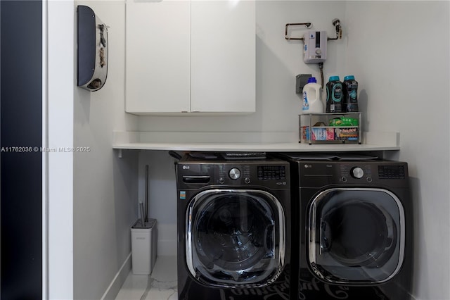 washroom with cabinet space, washing machine and dryer, marble finish floor, and baseboards