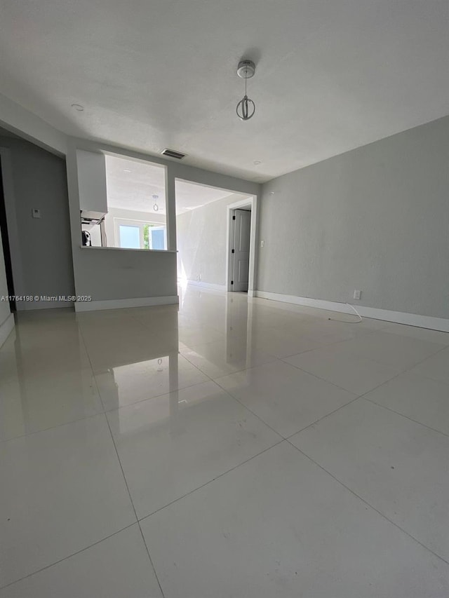 tiled spare room with visible vents and baseboards