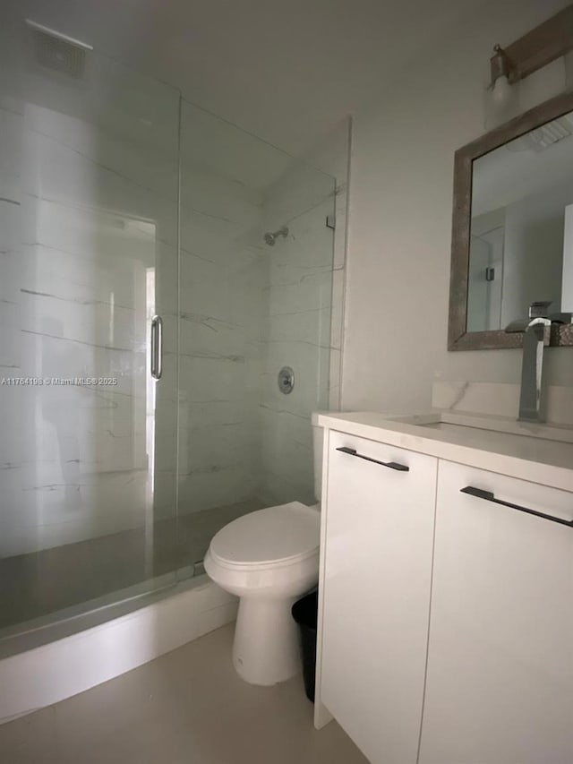 full bathroom with toilet, a stall shower, and vanity