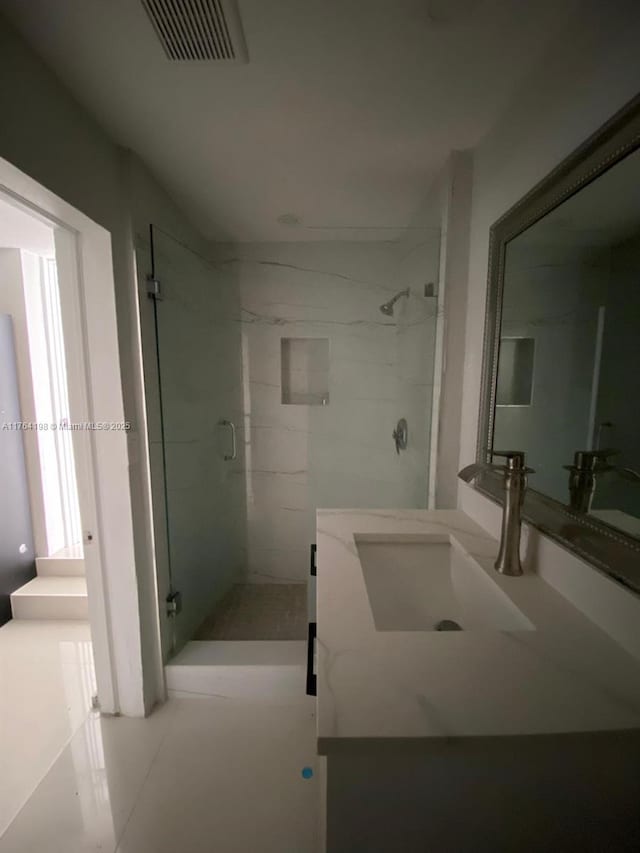 full bathroom featuring visible vents, a shower stall, and vanity