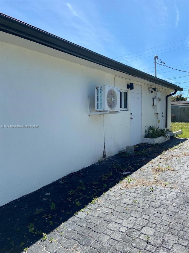 view of home's exterior featuring ac unit and stucco siding