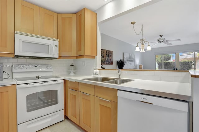 kitchen featuring white appliances, light brown cabinets, a sink, decorative backsplash, and light countertops