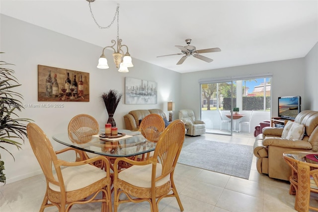 dining room with light tile patterned floors and ceiling fan with notable chandelier