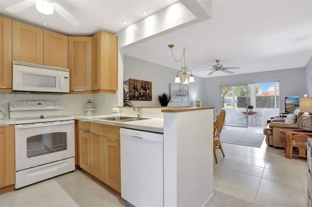 kitchen featuring a sink, white appliances, open floor plan, and ceiling fan with notable chandelier