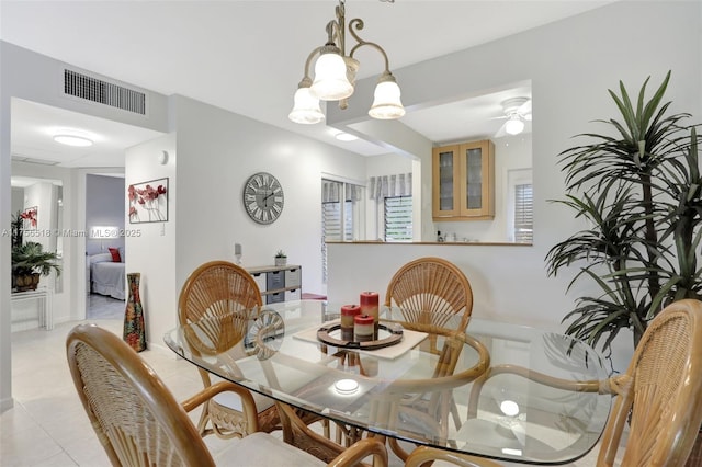 dining room with light tile patterned floors, visible vents, and ceiling fan