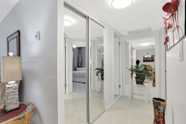 hall featuring light tile patterned floors and visible vents