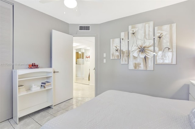 tiled bedroom featuring a ceiling fan and visible vents