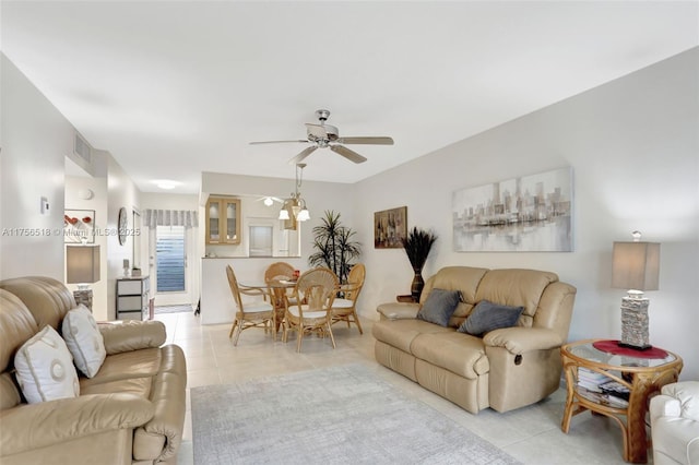 living area featuring light tile patterned floors, visible vents, and ceiling fan